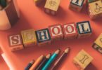 wooden cubes with letters and color pencils school tuition education