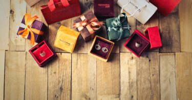 assorted gift boxes on brown wooden floor surface