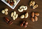 variety of brown nuts on brown wooden panel high angle photo