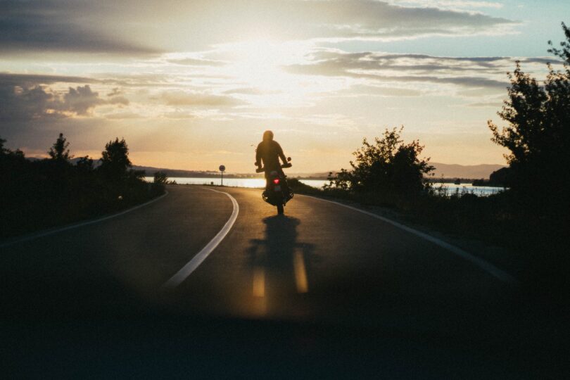 person riding motorcycle during golden hour