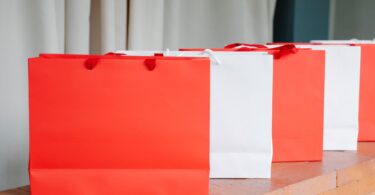 similar white and red shopping bags on brick counter