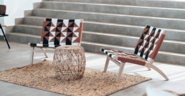 chairs with african style pattern basket table and sandy rug with gray steps in background