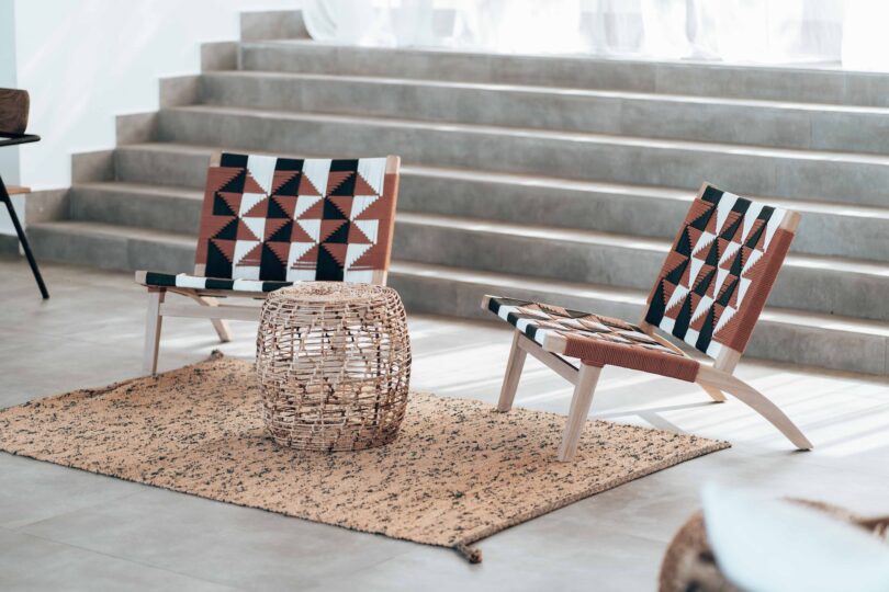 chairs with african style pattern basket table and sandy rug with gray steps in background