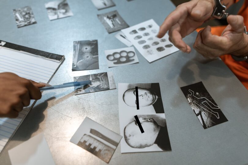 a person pointing on to the photographs