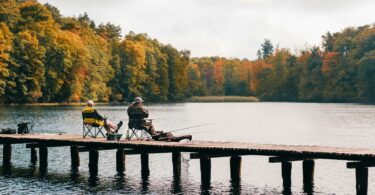 two men fishing on lake