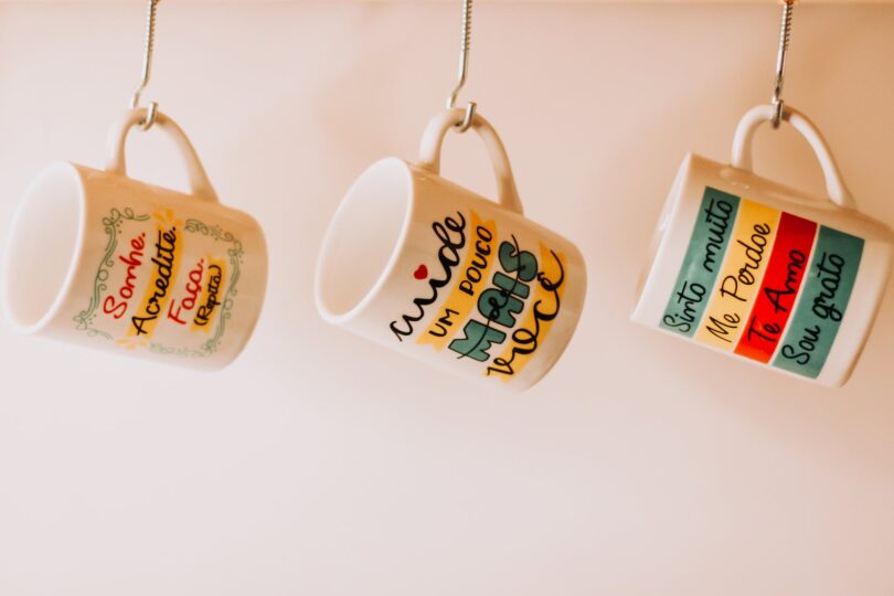close up photo of hanging ceramic mugs