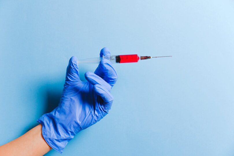 person holding syringe