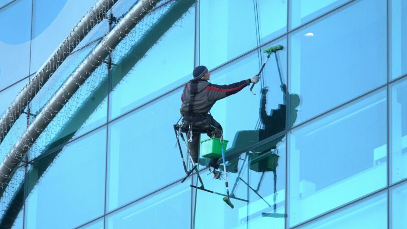 photo of a man cleaning windows