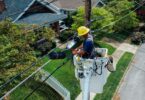 photography of man repairing electrical wires